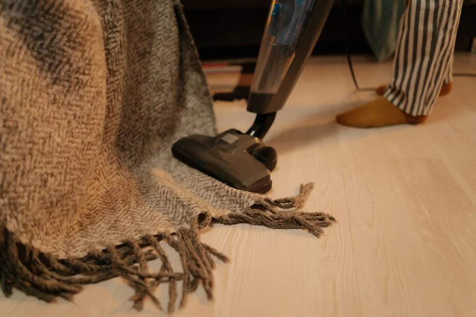 Person using spray bottle and cloth for cleaning a kitchen shelf, ensuring hygiene and cleanliness.